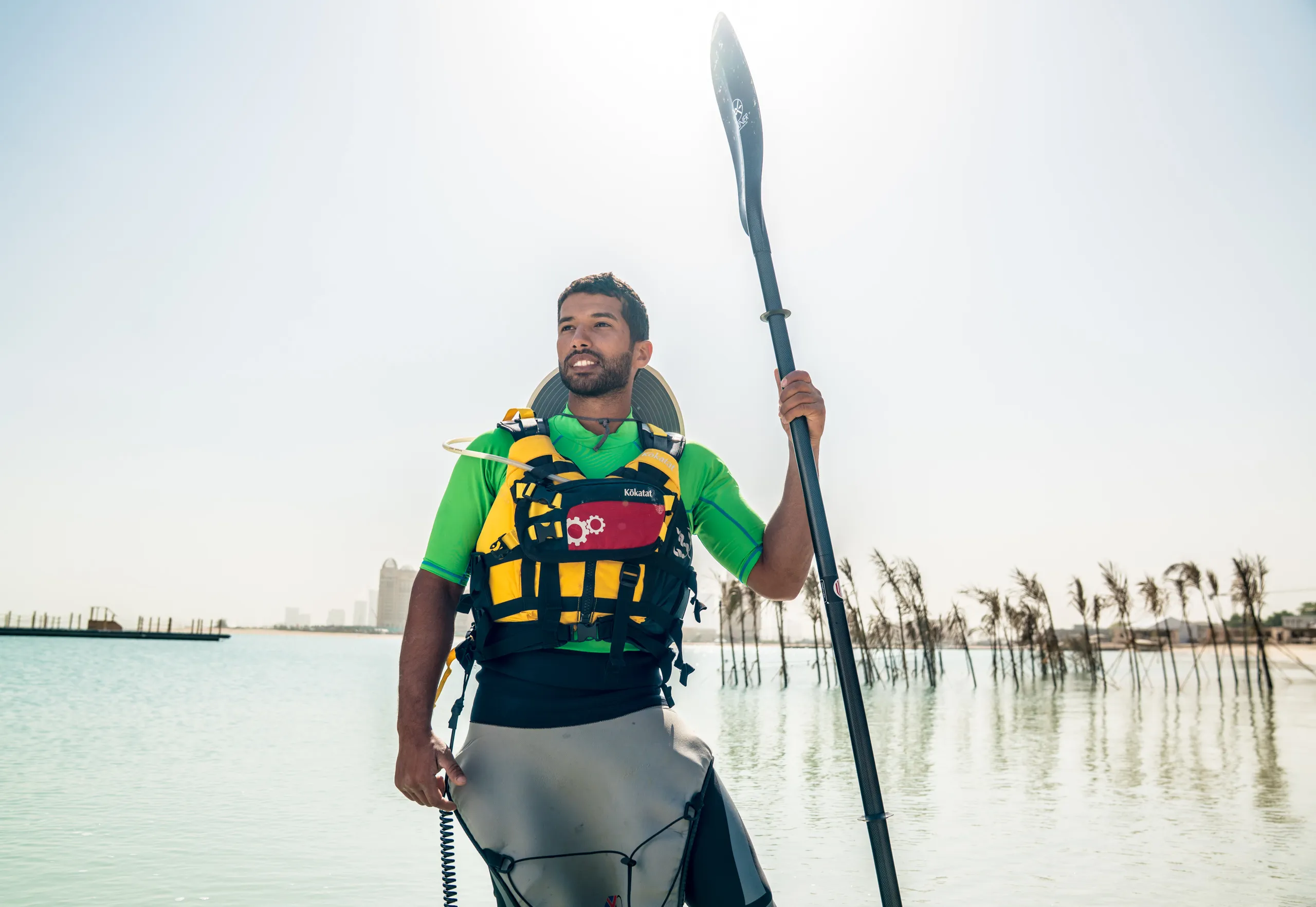 A paddler holding his paddle against the sky