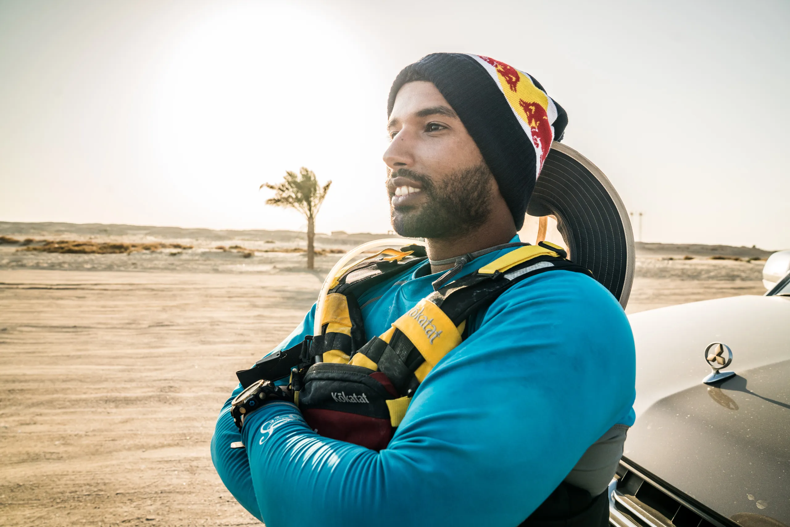A paddler standing in the desert with his arms crossed
