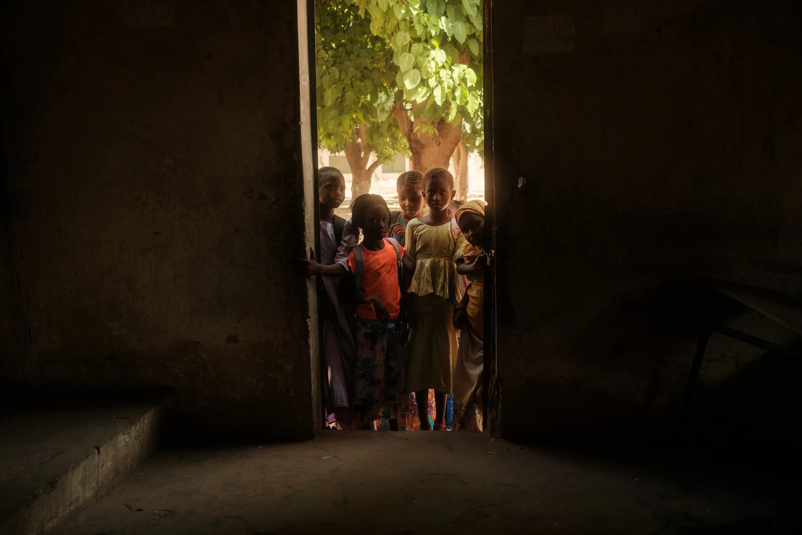 Children looking out of a classroom door