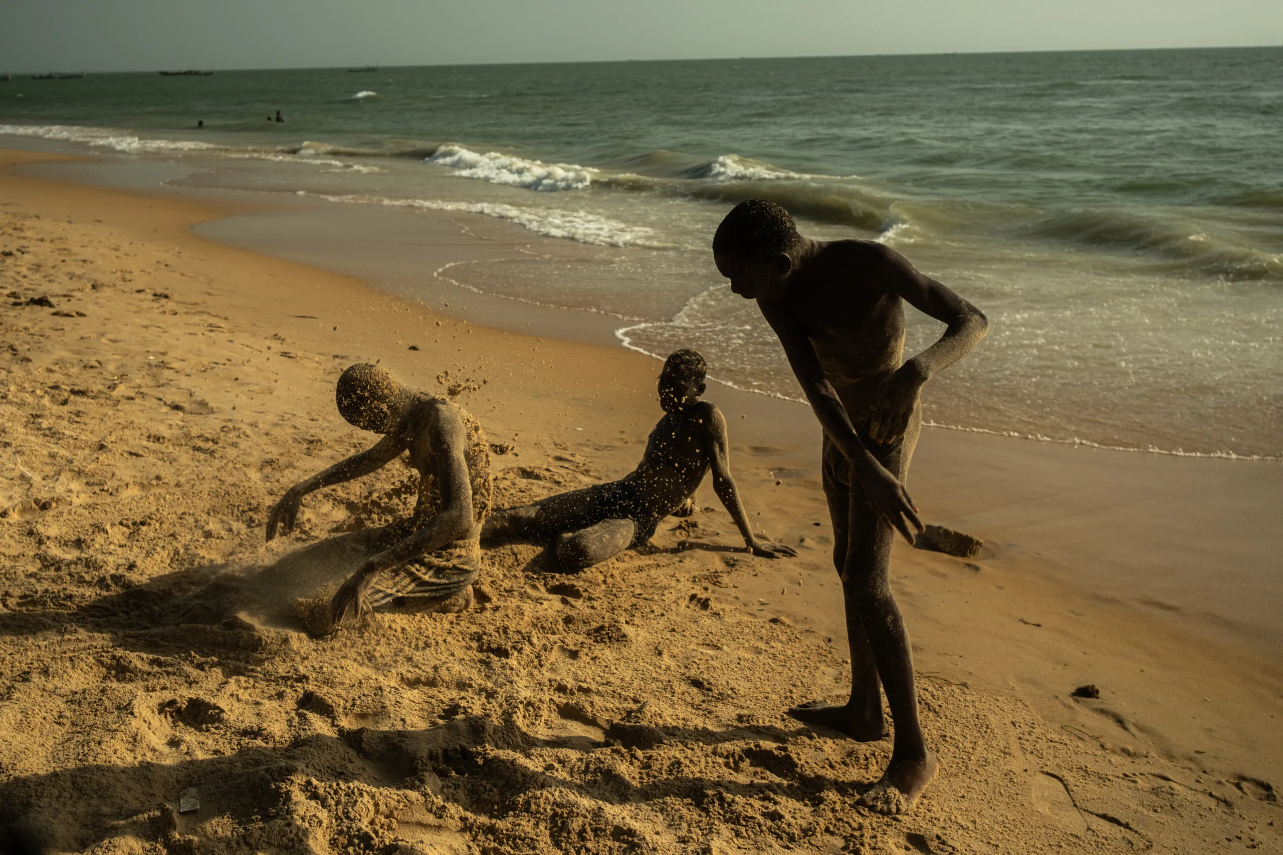 Children playing in the sand at the beach