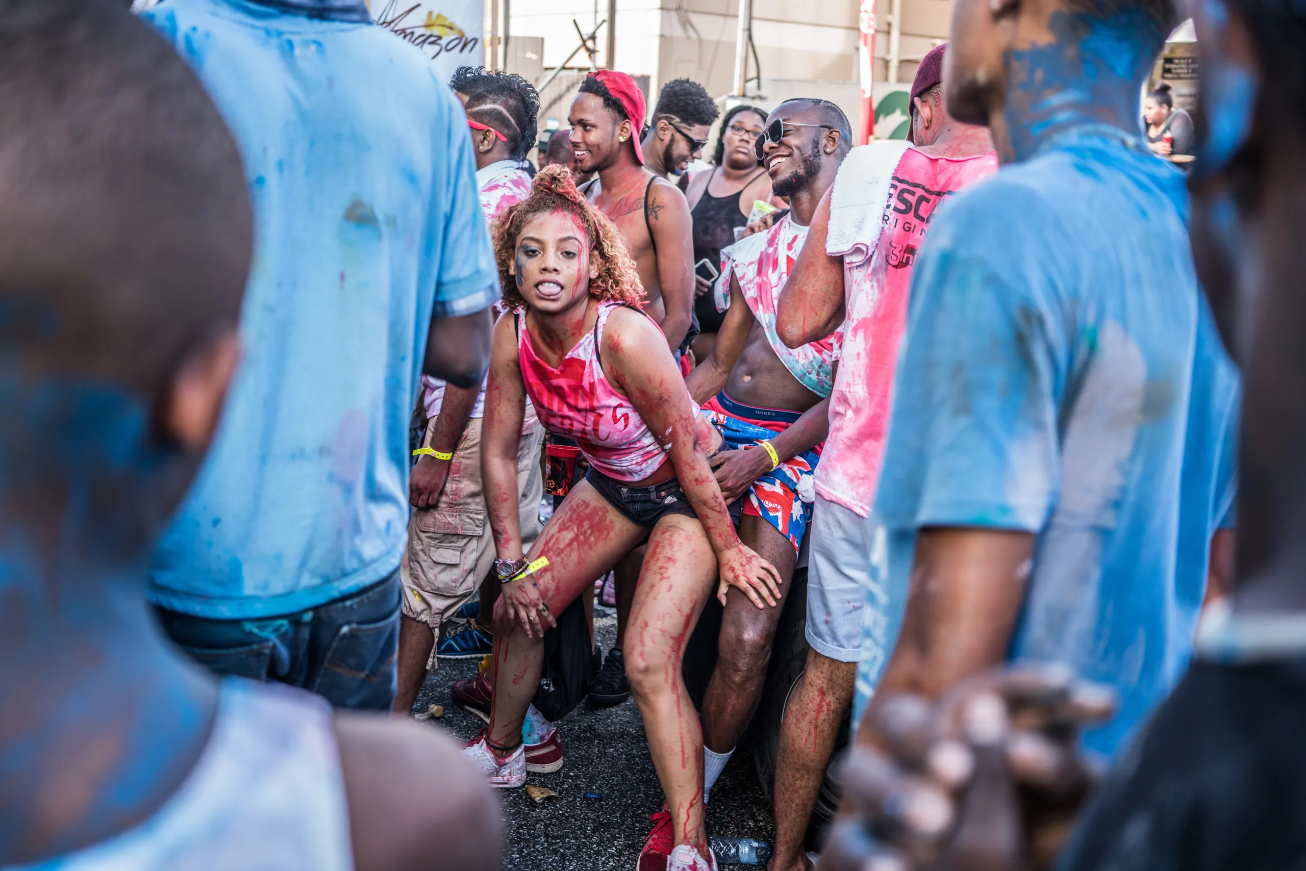 A crowd covered in blue paint at J'Ouvert